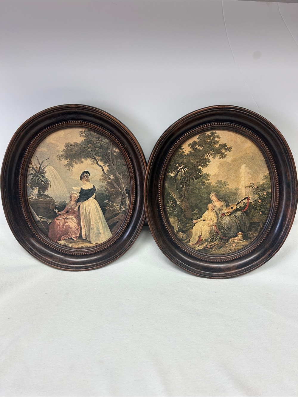 Vintage pair of oval framed “Copper Craft Guild “  reproduction oil paintings